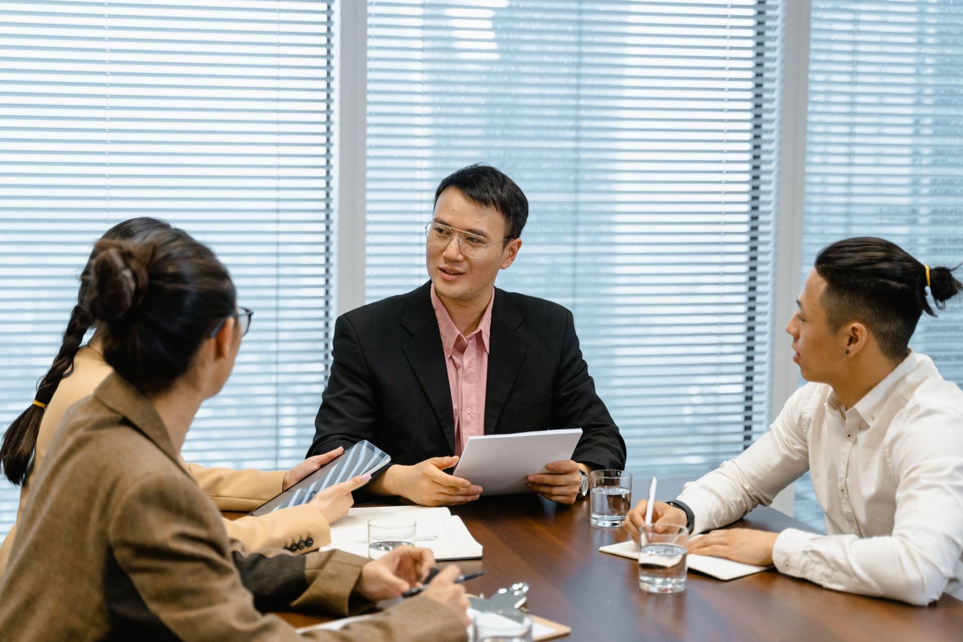 A small team talking through plans together around a meeting table